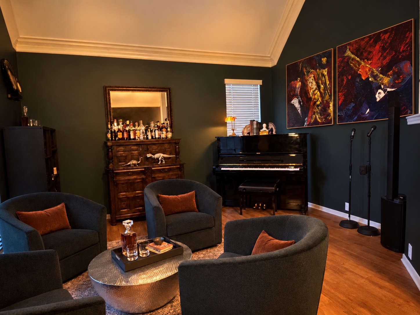 Finished dark green music lounge with four chairs, piano, and colorful artwork